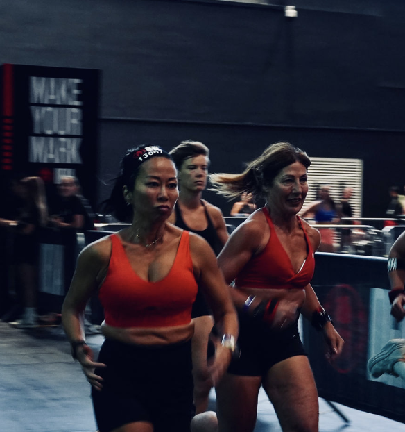 Line racing alongside other competitors in a dark indoor arena